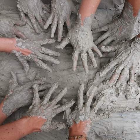 hands-covered-in-clay
